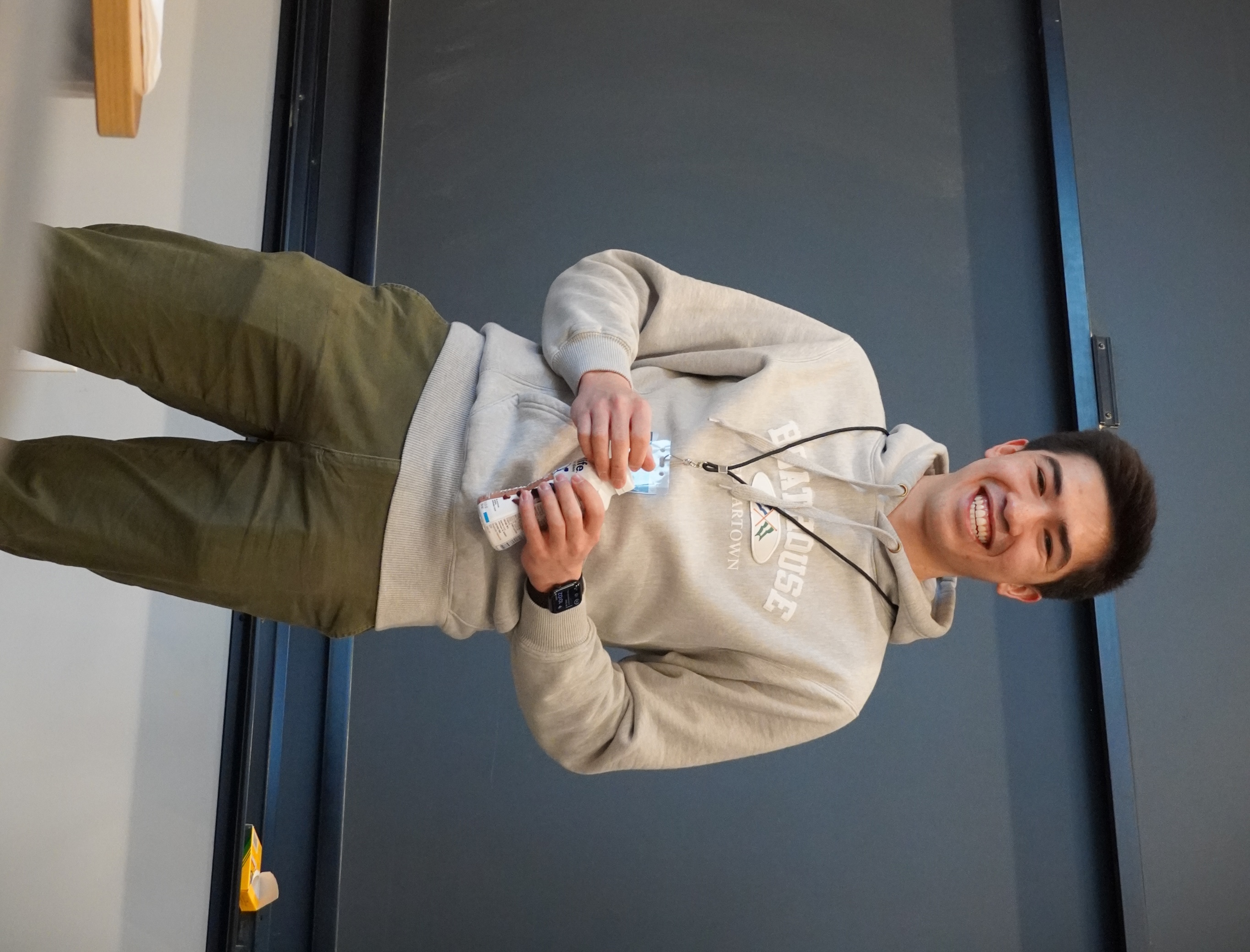 Ben, a JumboCode member, smiling in front of a blackboard